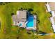 Top-down aerial view of community pool, jacuzzi, and lake in the middle of a manicured landscape at 2812 Heritage Ln # 2812, Bradenton, FL 34209