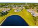 Aerial view of community with a lake, pool, and well-maintained green spaces at 2812 Heritage Ln # 2812, Bradenton, FL 34209
