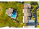 Aerial view showcasing community pool, clubhouse, and residential area near parking and landscaping at 2812 Heritage Ln # 2812, Bradenton, FL 34209