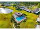 Stunning aerial view of the community pool, clubhouse, lake, and meticulously maintained landscaping at 2812 Heritage Ln # 2812, Bradenton, FL 34209