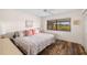 Cozy bedroom with wood floors, ceiling fan, and a large window for natural light at 2812 Heritage Ln # 2812, Bradenton, FL 34209