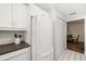 Bright kitchen featuring white cabinets, modern appliances, and a view into the dining area at 2812 Heritage Ln # 2812, Bradenton, FL 34209