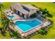 Beautiful community pool and jacuzzi surrounded by chairs, tables, and lush tropical landscaping at 2812 Heritage Ln # 2812, Bradenton, FL 34209