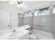 Well-lit bathroom featuring a bathtub and tiled shower at 455 Park Trace Blvd, Osprey, FL 34229