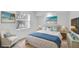Staged bedroom with a queen bed, blue accents, a large window and white furniture at 455 Park Trace Blvd, Osprey, FL 34229