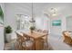 Dining room with wood table, seating for six, large window, and modern chandelier at 455 Park Trace Blvd, Osprey, FL 34229