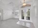 Light-filled entryway featuring tile flooring, glass double doors, and elegant light fixtures at 455 Park Trace Blvd, Osprey, FL 34229