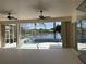 Spacious lanai providing scenic views of the pool and lake, enhancing outdoor living at 455 Park Trace Blvd, Osprey, FL 34229