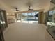 Bright lanai boasting a summer kitchen and expansive views of the pool and picturesque lake at 455 Park Trace Blvd, Osprey, FL 34229