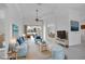 Staged living room with blue decor, comfortable seating, stylish furnishings and water view at 455 Park Trace Blvd, Osprey, FL 34229