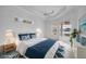 Serene bedroom with a king bed, blue accents, large window, and sliding door with outdoor access at 455 Park Trace Blvd, Osprey, FL 34229