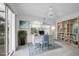Bright office space with large windows, ceiling fan, built-in shelving, and stylish decor at 455 Park Trace Blvd, Osprey, FL 34229