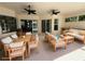 Inviting covered patio with ceiling fans and comfortable seating, perfect for outdoor relaxation and entertaining at 455 Park Trace Blvd, Osprey, FL 34229