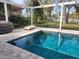 Enclosed pool and patio area with canal views and grilling station at 4906 Primrose Path, Sarasota, FL 34242