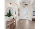 Light-filled entry with hardwood floors, a console table, and a large round mirror at 4913 Edisto Ct, Lakewood Ranch, FL 34211