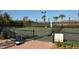 Well-maintained tennis court with seating at 5870 Cavano Dr, Sarasota, FL 34231