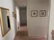 Hallway with light walls and carpeted floor at 611 Gulf N Dr # D24, Bradenton Beach, FL 34217