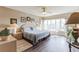 Spacious main bedroom with large windows, hardwood floor, and ample natural light at 619 Cedars Ct, Longboat Key, FL 34228