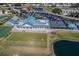 Aerial view of community clubhouse, driving range, and pond at 6591 Fairway Gardens Dr # 2-102, Bradenton, FL 34203