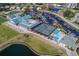 Aerial view showing clubhouse, pool, tennis courts, and parking at 6591 Fairway Gardens Dr # 2-102, Bradenton, FL 34203