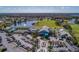 Aerial view of community clubhouse, pool, tennis courts, and golf course at 6591 Fairway Gardens Dr # 2-102, Bradenton, FL 34203