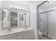 Bathroom with a double vanity, large mirror, and shower at 6591 Fairway Gardens Dr # 2-102, Bradenton, FL 34203