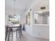 Dining area with a wooden table, chairs, and kitchen pass-through at 6591 Fairway Gardens Dr # 2-102, Bradenton, FL 34203