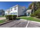 Condo with teal accents, attached garage, and a manicured lawn at 6591 Fairway Gardens Dr # 2-102, Bradenton, FL 34203
