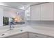 Kitchen with a breakfast bar overlooking the living room and white cabinetry at 6591 Fairway Gardens Dr # 2-102, Bradenton, FL 34203