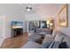 Living room with sectional sofa, wood floors, and large TV at 6591 Fairway Gardens Dr # 2-102, Bradenton, FL 34203