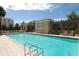 Relaxing pool area with plenty of lounge chairs for sunbathing at 750 N Tamiami Trl # 302, Sarasota, FL 34236