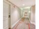 Building hallway with striped wallpaper and carpet at 750 N Tamiami Trl # 302, Sarasota, FL 34236