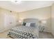 King-size bed in bright bedroom with double closet doors and nightstands at 750 N Tamiami Trl # 302, Sarasota, FL 34236