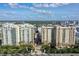 Two elegant condo buildings with a wide, tree-lined entrance at 750 N Tamiami Trl # 302, Sarasota, FL 34236