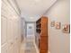 Bright hallway with wood flooring, built-in shelving, and ample closet space at 750 N Tamiami Trl # 302, Sarasota, FL 34236