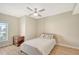 Bedroom with full-size bed, dresser, and window with natural light at 750 N Tamiami Trl # 302, Sarasota, FL 34236