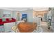 Open living room featuring a red couch and kitchen views at 750 N Tamiami Trl # 302, Sarasota, FL 34236