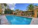 Refreshing pool with comfortable seating and a pergola at 750 N Tamiami Trl # 302, Sarasota, FL 34236