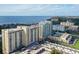 Aerial perspective of luxury condos near the water, showcasing amenities and parking at 750 N Tamiami Trl # 302, Sarasota, FL 34236