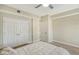 Bedroom with a queen-size bed, ceiling fan and double doors at 750 N Tamiami Trl # 302, Sarasota, FL 34236