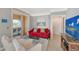 Living area featuring red sofa, white armchairs, and a view at 750 N Tamiami Trl # 302, Sarasota, FL 34236