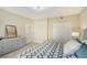 Spacious bedroom with a large bed, dresser, and double doors leading to a closet at 750 N Tamiami Trl # 302, Sarasota, FL 34236