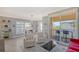 Open living space with balcony access, seating area and breakfast bar at 750 N Tamiami Trl # 302, Sarasota, FL 34236