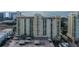 Aerial view of building, parking, and water at 750 N Tamiami Trl # 302, Sarasota, FL 34236