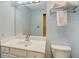 Clean bathroom with single sink vanity, toilet, and mirrored medicine cabinet at 750 N Tamiami Trl # 302, Sarasota, FL 34236