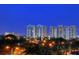 Night view of upscale condo buildings with city lights and lush landscaping at 750 N Tamiami Trl # 302, Sarasota, FL 34236