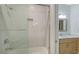 Bathroom with white scalloped tile shower and modern vanity at 2492 S Milmar Dr, Sarasota, FL 34237