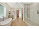 Spa-like bathroom with soaking tub and glass shower at 2492 S Milmar Dr, Sarasota, FL 34237