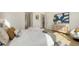 Main bedroom with plush bed and access to the bathroom at 2492 S Milmar Dr, Sarasota, FL 34237