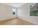 Well-lit bedroom with hardwood floors and two windows providing natural light at 2492 S Milmar Dr, Sarasota, FL 34237